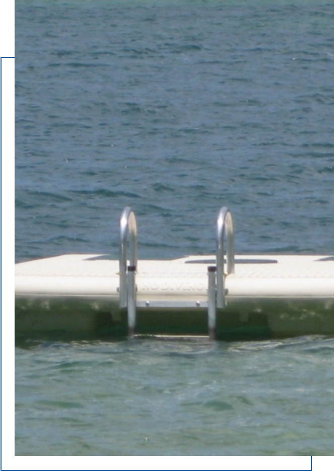 A white boat dock floating in the water.