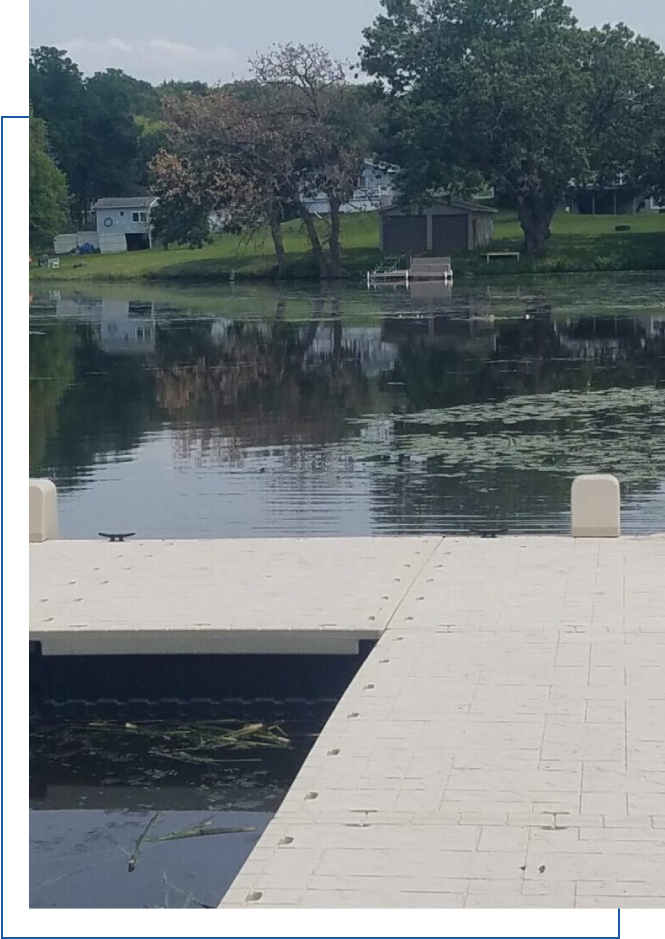 A dock with a boat in the middle of a lake.