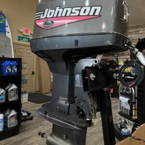 1999 130HP Johnson outboard motor in a showroom.