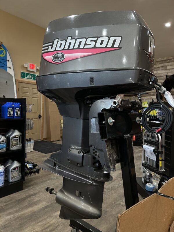 1999 130HP Johnson outboard motor in a showroom.