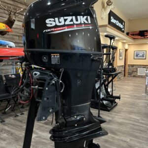 A 2019 140HP Suzuki 4 Stroke outboard is on display in a store.