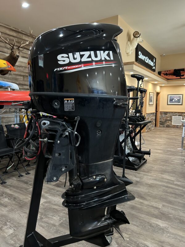 A 2019 140HP Suzuki 4 Stroke outboard is on display in a store.