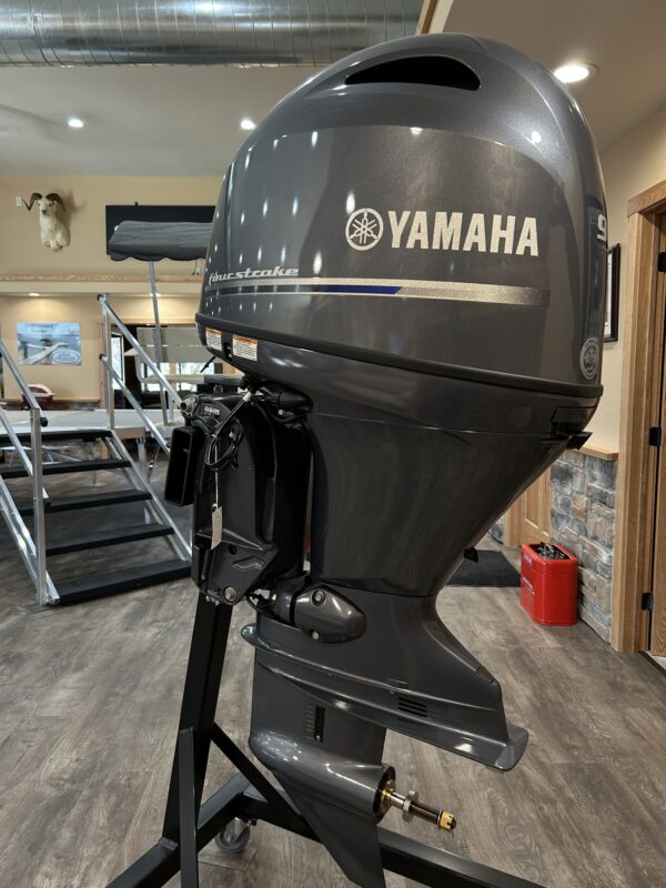 A 2023 90HP Yamaha 4 Stroke outboard is on display in a showroom.