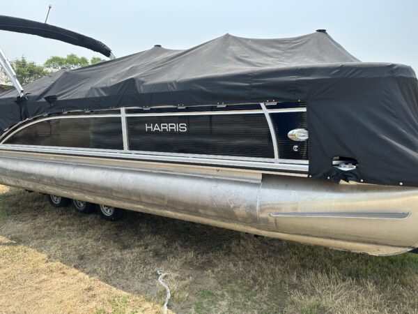 A 2019 Harris Tritoon 25' Pontoon with a cover on it.