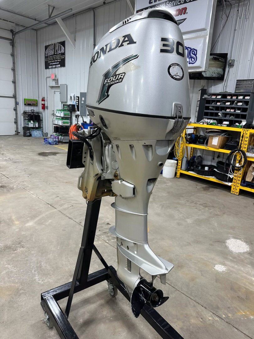 Silver Honda 30‑hp outboard motor on stand