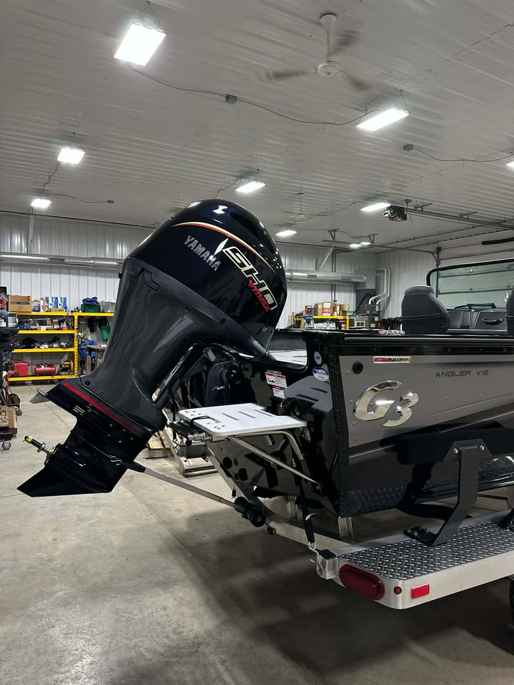 G3 aluminum boat with Yamaha outboard in workshop