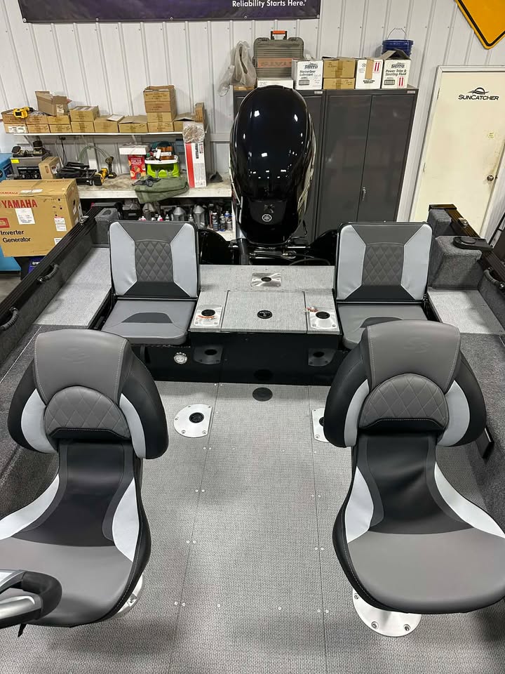 Bass boat cockpit with gray seats and outboard