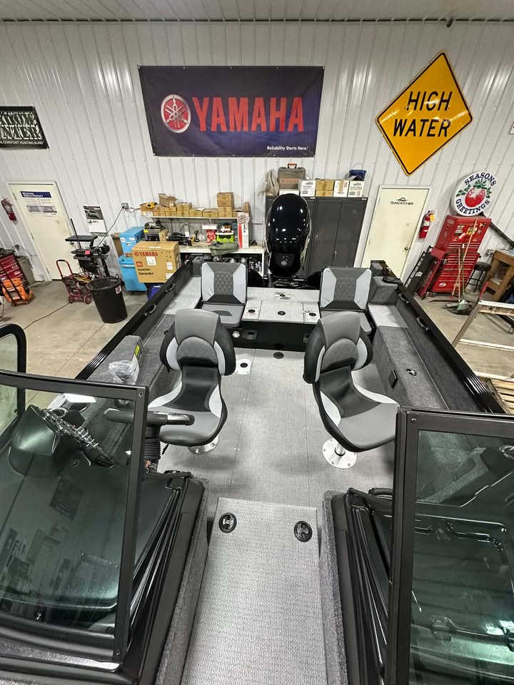 Fishing boat interior in garage with Yamaha sign