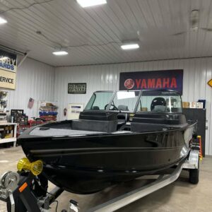 Sleek black motorboat on trailer in showroom