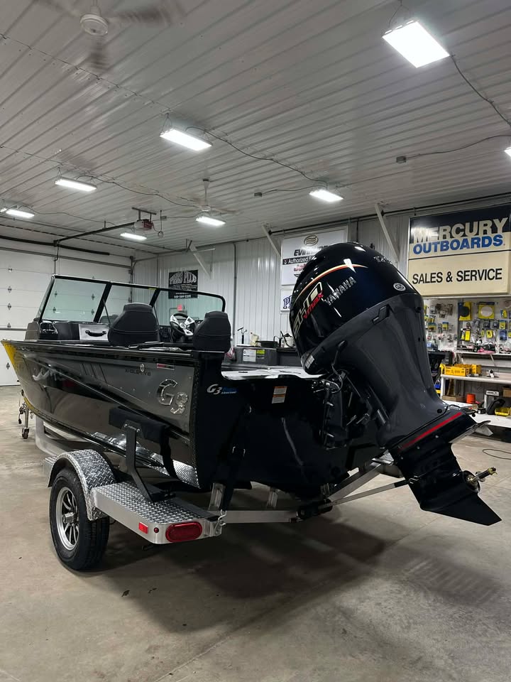Black aluminum fishing boat with Mercury outboard