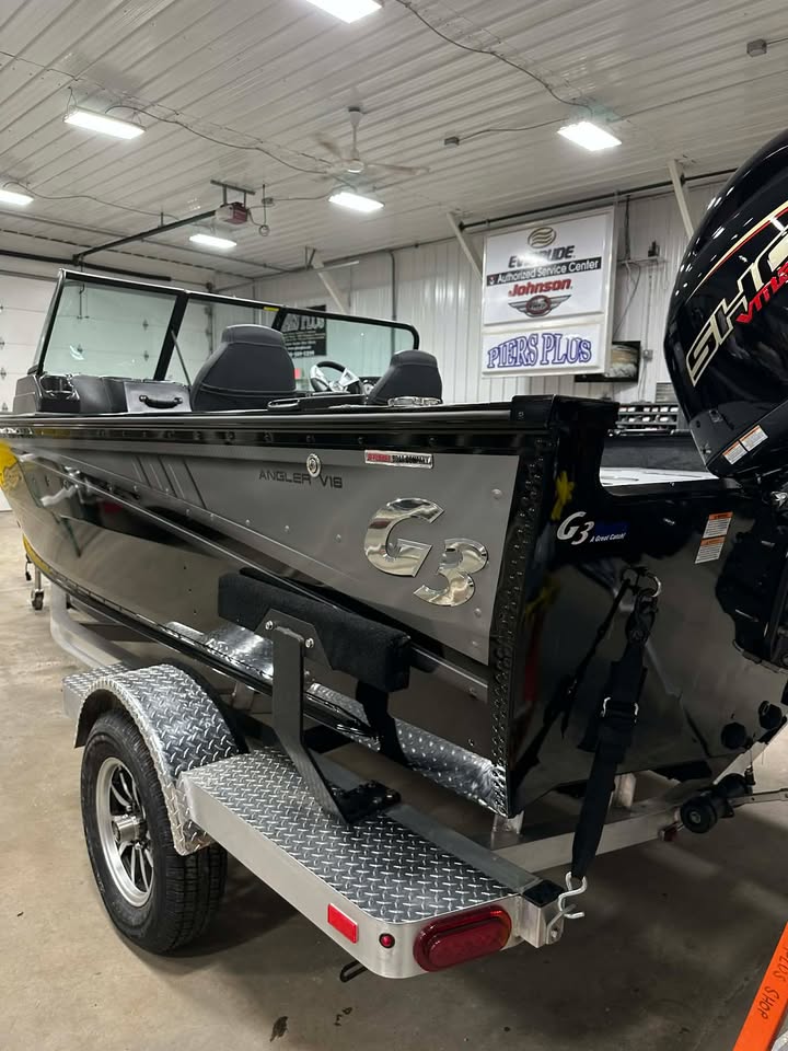 Black G3 aluminum fishing boat on trailer