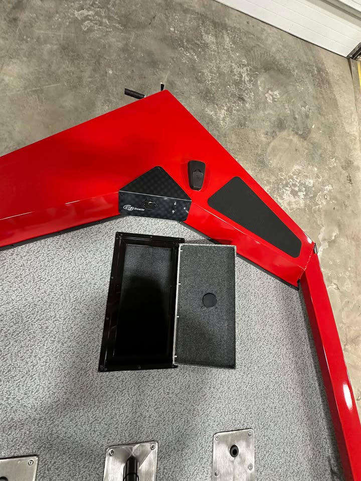 Red bass boat bow with open storage compartment