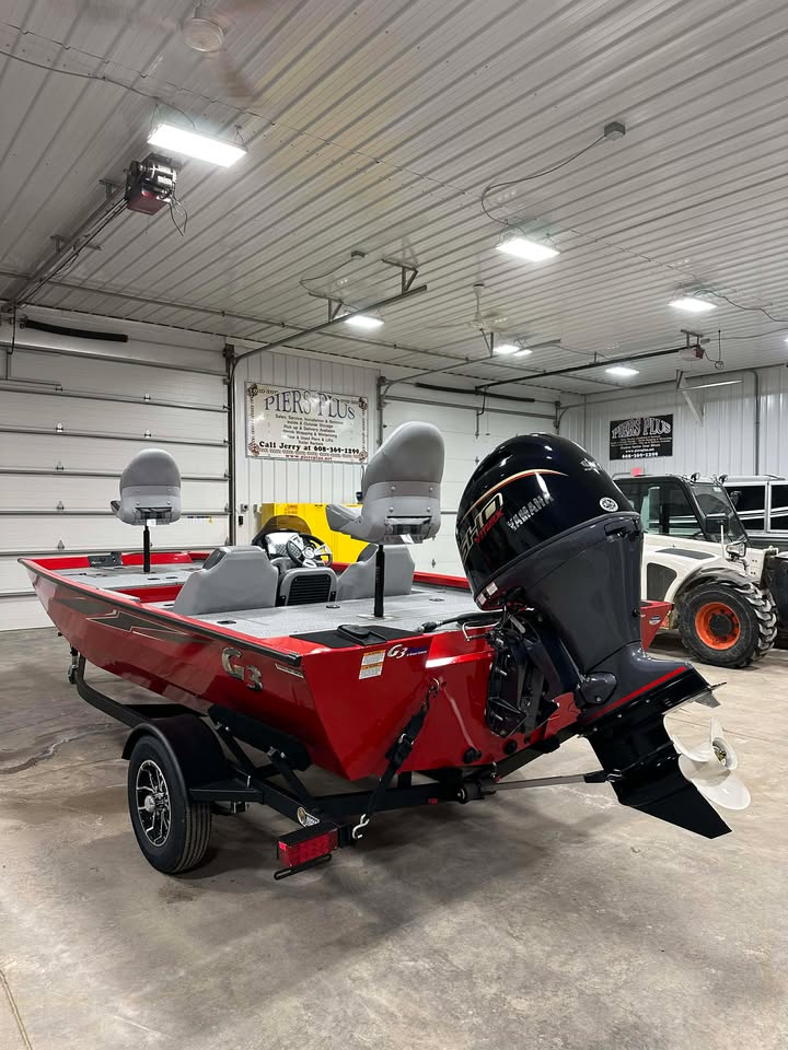 Red bass boat with Yamaha motor on trailer