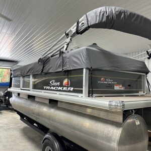 Sun Tracker pontoon boat on trailer in garage