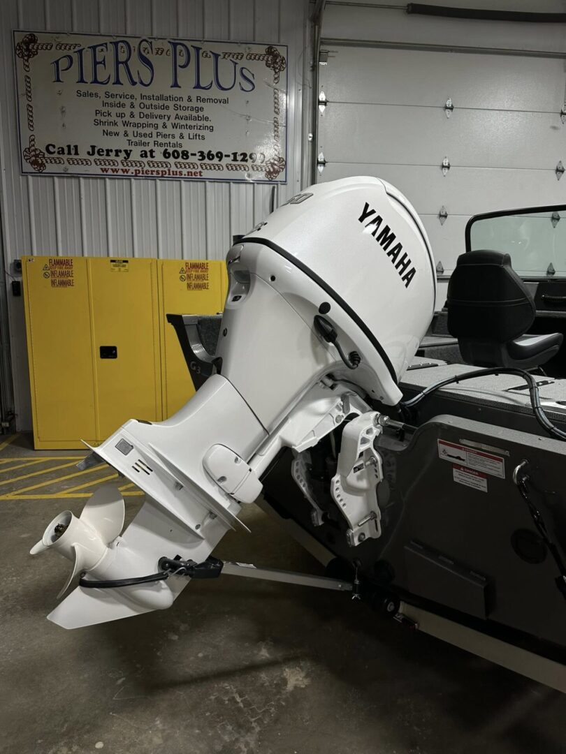 White Yamaha outboard motor mounted on boat