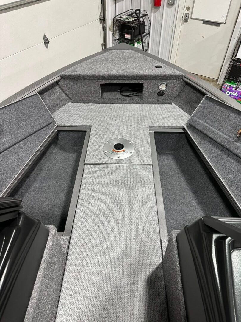 Carpeted fishing boat bow with storage compartments