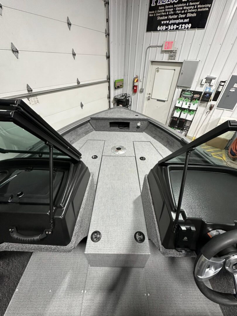Carpeted bass boat bow deck with dual consoles
