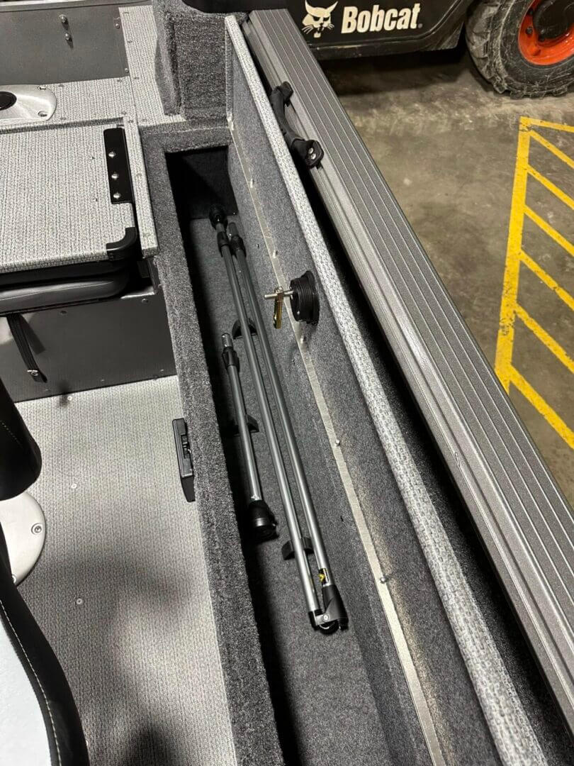 Carpeted boat rod locker with folded rods