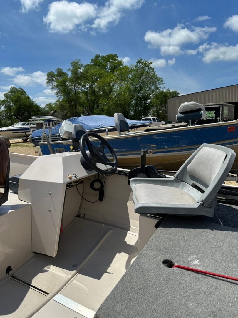 Fishing boat cockpit with steering wheel and seat