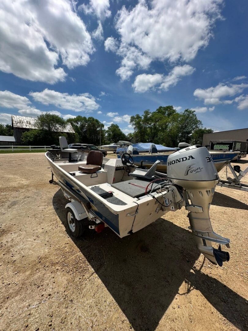 Small aluminum skiff parked under cloudy sky
