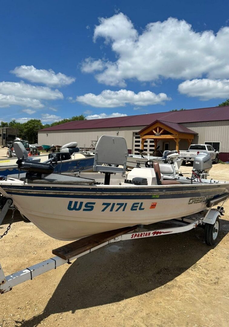 Fishing boat on trailer parked by building