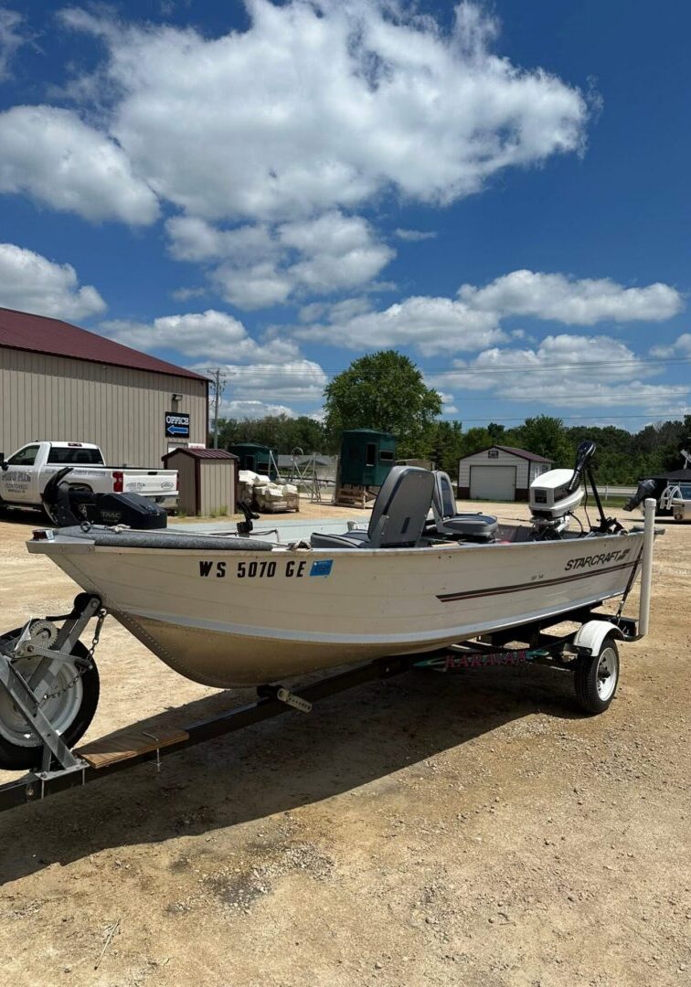White Starcraft skiff resting on gravel trailer